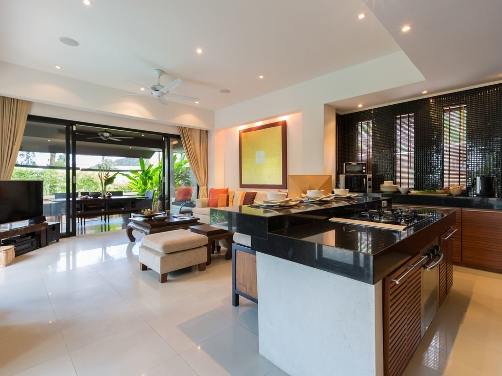 Kitchen looking into living room area and outdoor dining pavilion that seats 10